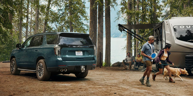 2026 Tahoe parked in a wooded area, showcasing its rugged design and family-friendly features.